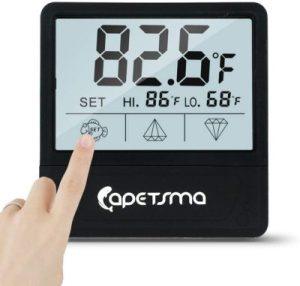 someone setting a thermometer i=for an aquarium